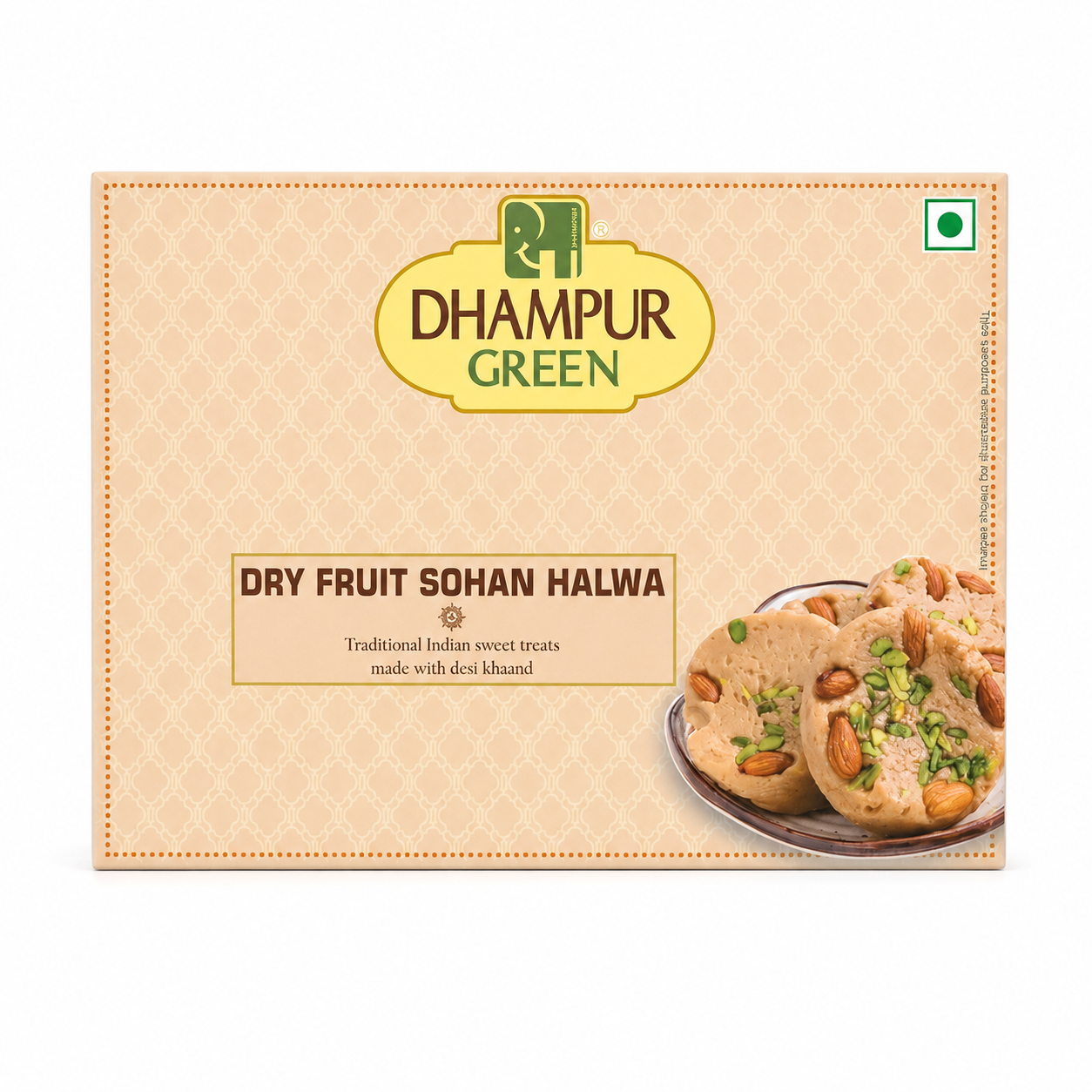 A box of DHAMPUR GREEN Dry Fruit Sohan Halwa, featuring a light beige patterned background with a yellow brand logo and an image of the halwa cookies on a plate with almonds and green chives.