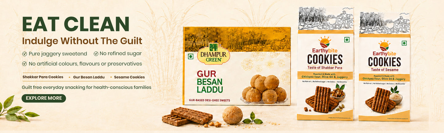 Promotional banner for Darumari Green cookies, featuring three product boxes (Gur Besan Laddu, Cookies, and Easy Cookies) alongside loose cookies and wafri pieces on a light beige background with green and black text.