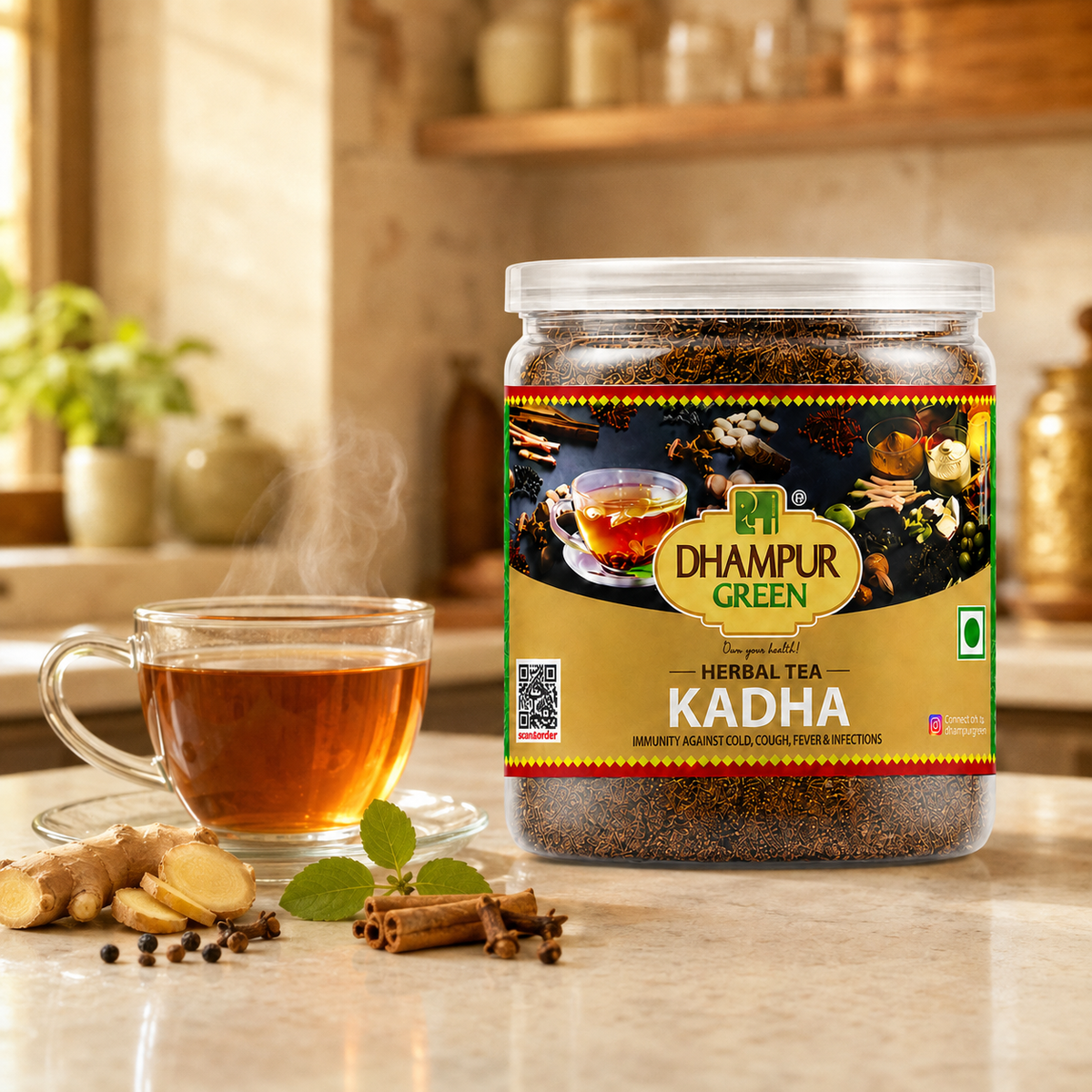 A jar of Dhampur Green Herbal Tea Kadha is displayed on a kitchen counter next to a glass of brewed tea, ginger root, cinnamon, and mint leaves, with a warm kitchen background.