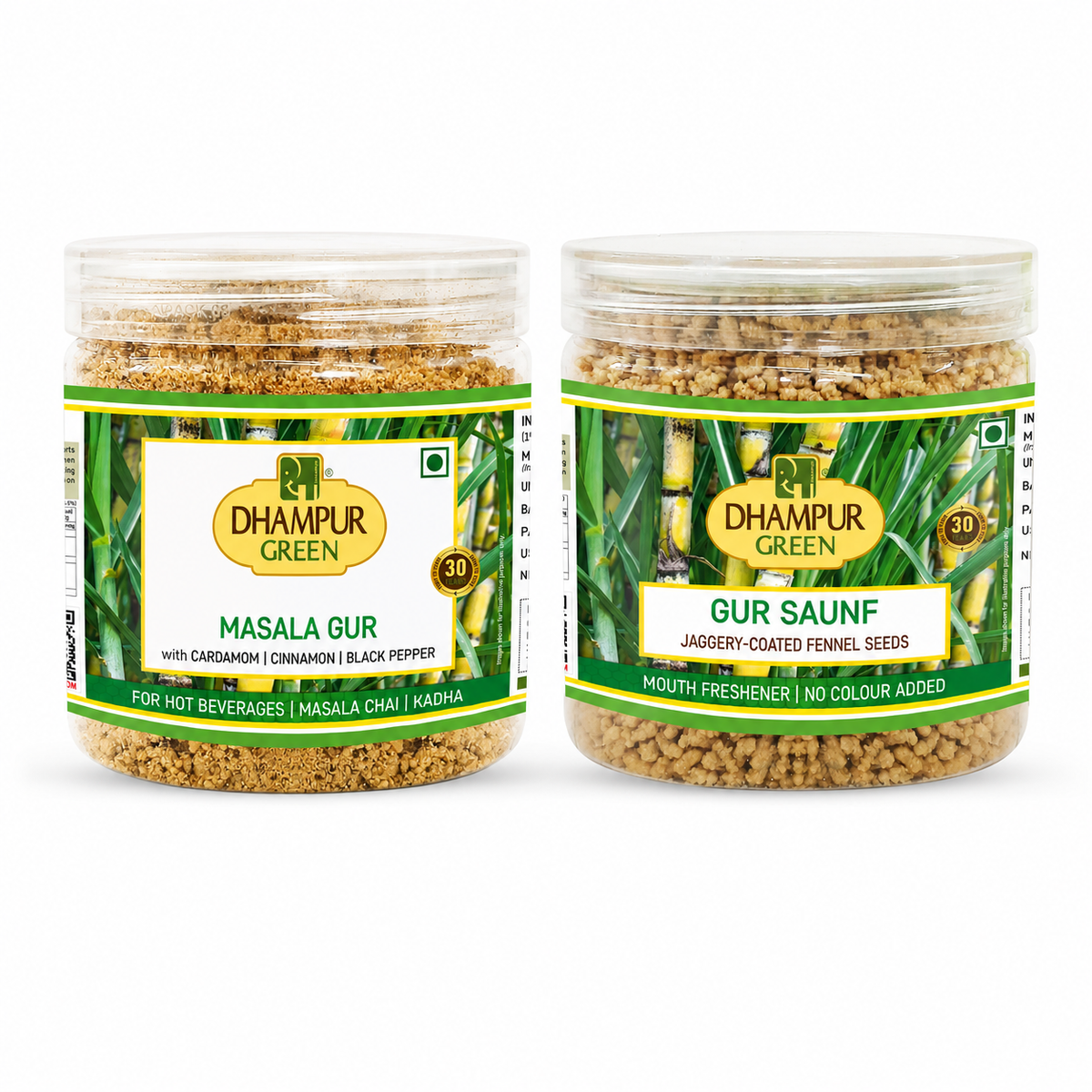 Two clear plastic jars of Dhampur Green spices on a white background, one labeled Masala Gur and the other Gur Saunf.