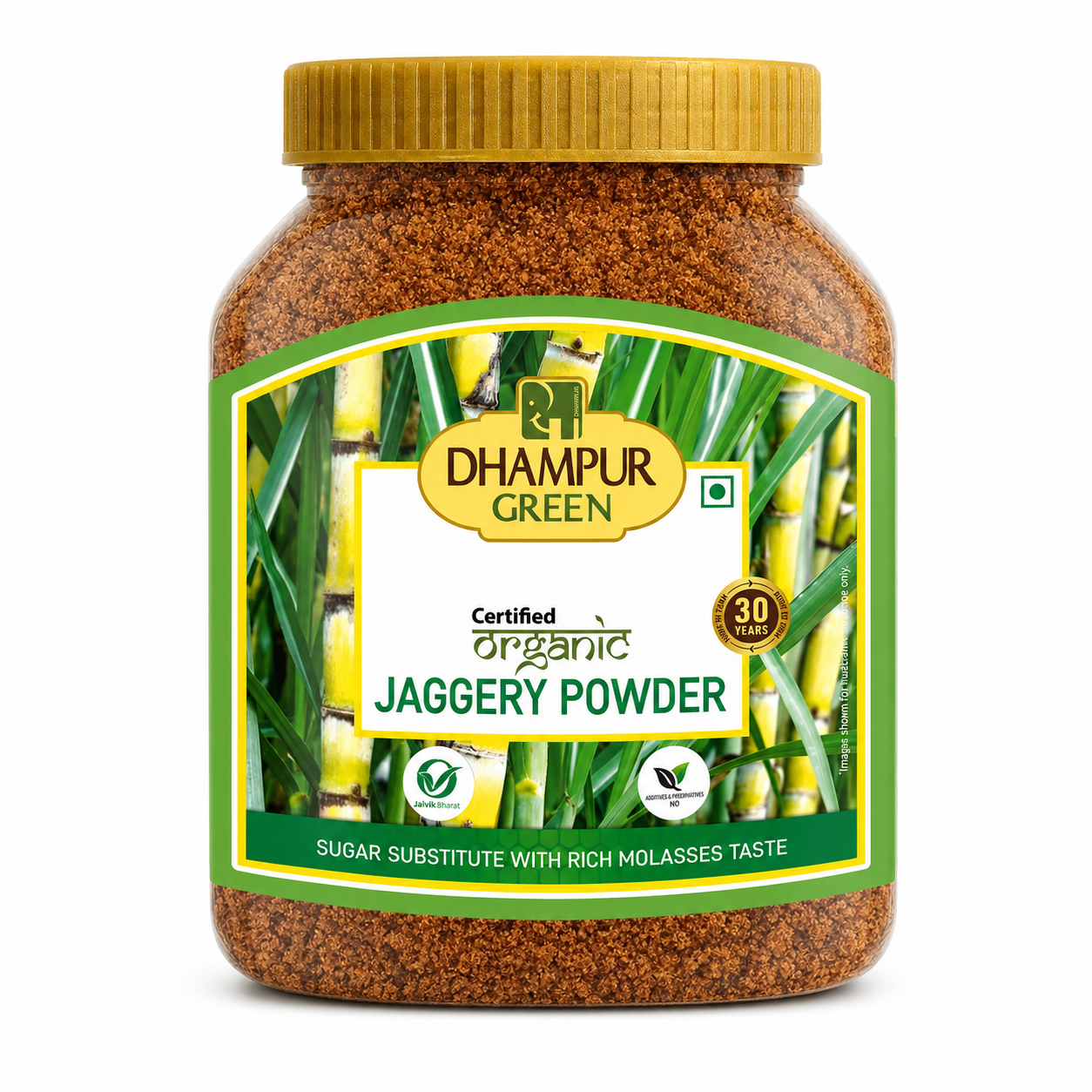A jar of Dhampur Green Certified Organic Jaggery Powder on a white background. The product is in a clear plastic jar showing the brown jaggery powder inside, with a gold ribbed lid and a green and yellow label featuring sugarcane imagery.