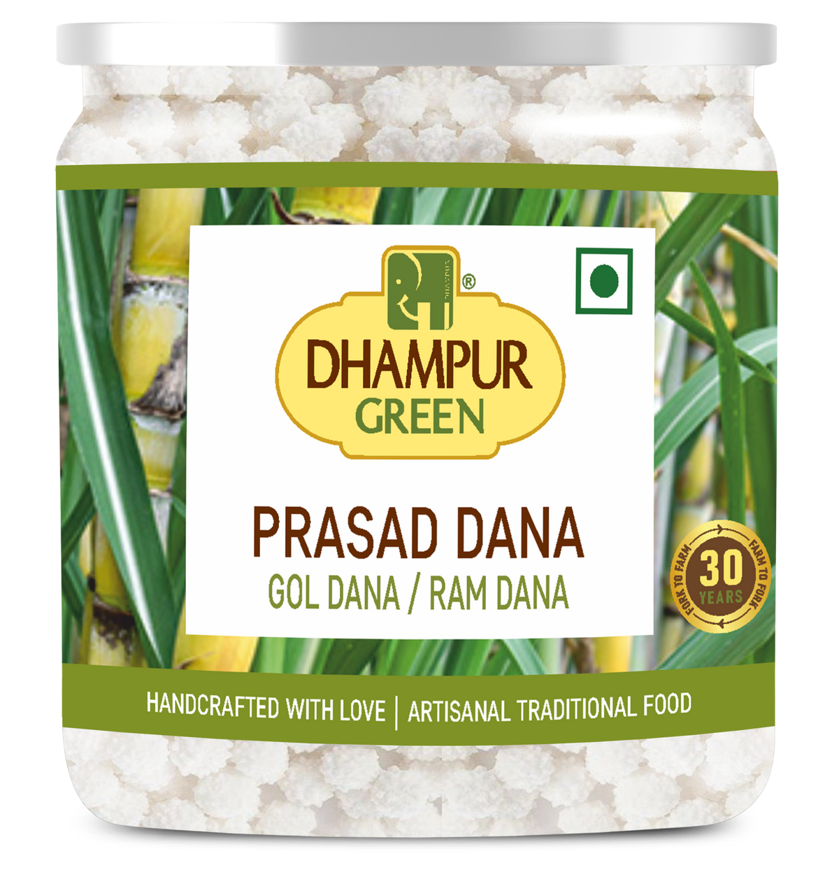 A jar of Dhampur Green Prasad Dana (Gol Dana / Ram Dana) against a white background. The jar contains white, crystalline powdered sweets and features a label with green leaves, yellow accents, and the Dhampur Green logo.