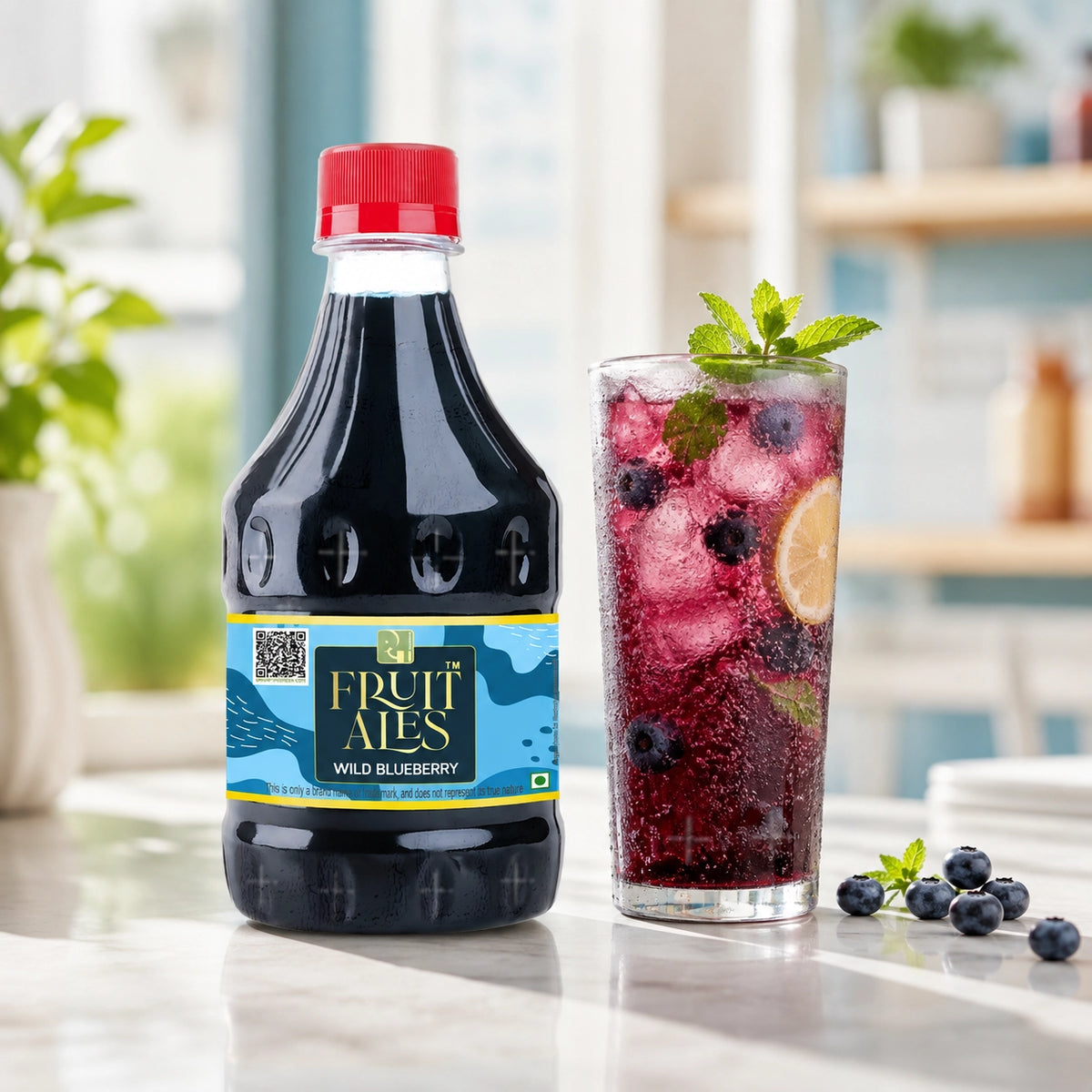 A bottle of Fruit Ales Wild Blueberry beverage stands on a countertop beside a tall glass filled with a blueberry drink, ice, mint, and a lemon slice, with blueberries nearby and a softly blurred kitchen background.