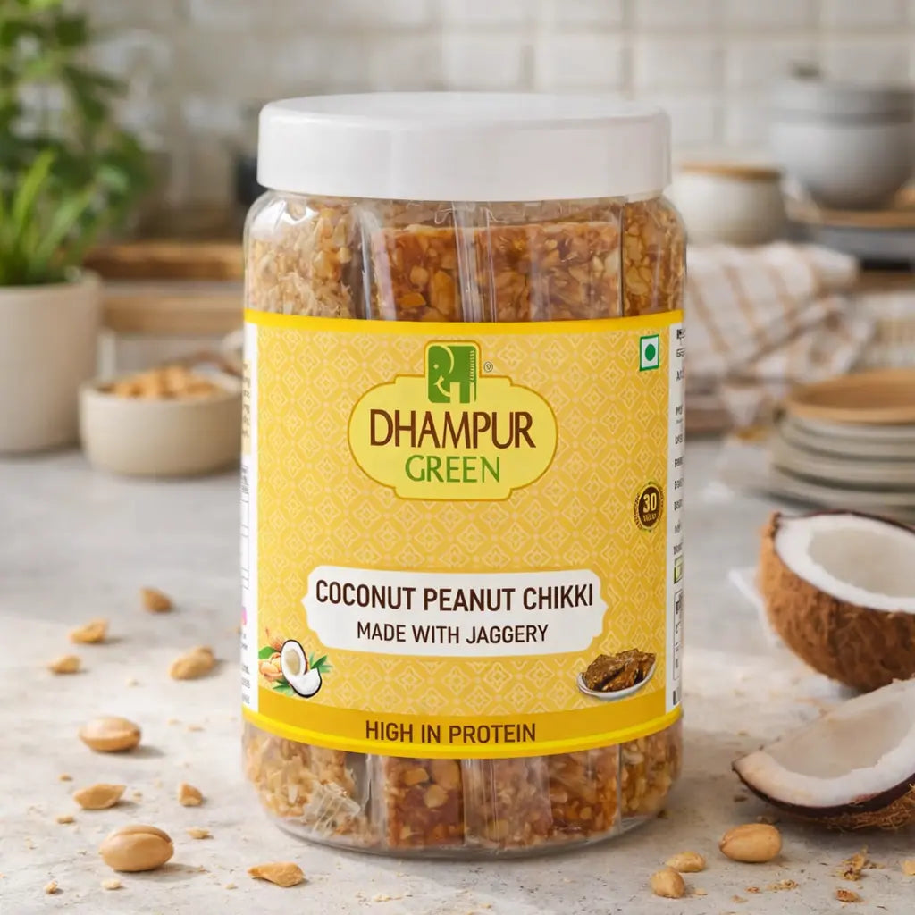 Jar of Dhampur Green Coconut Peanut Chikki on a kitchen counter with ingredients around